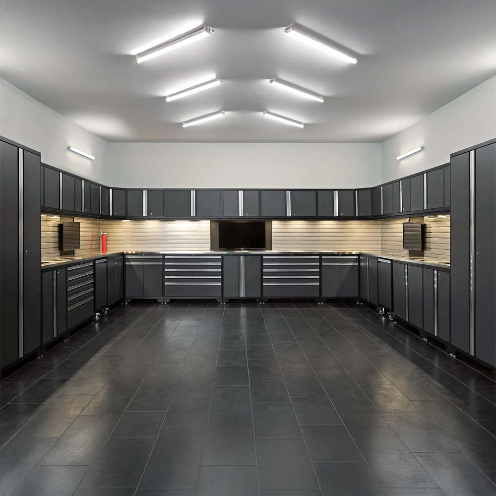 Spacious Garage With U Shaped Dark Cabinets Stainless Worktops Center Monitor