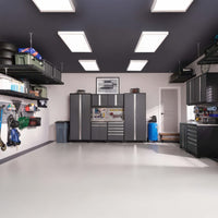 Spacious Organized Garage With Overhead Shelving LED Panel Lights And Grey Cabinet Workstation Along The Back Wall