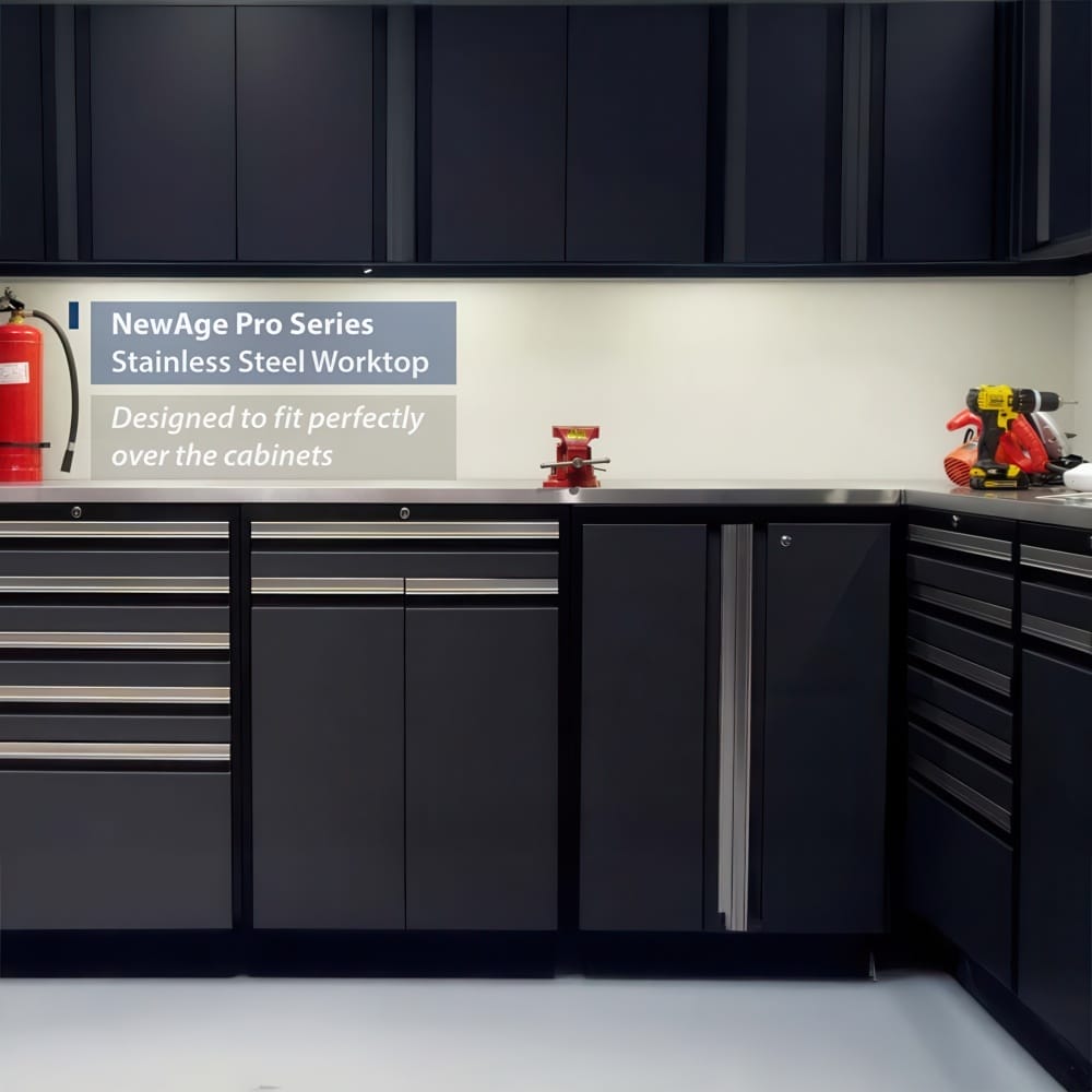 Stainless Steel Worktop Sits Perfectly Over Black Garage Cabinets Below Wall Units With Tools And A Fire Extinguisher In View