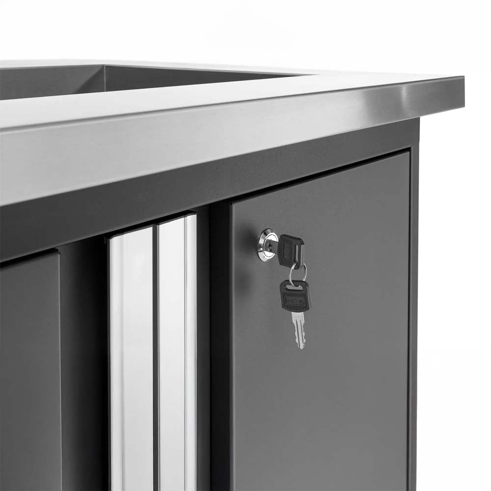 Stainless Topped Garage Cabinet With Keyed Lock And Keys Hanging From Door Cylinder
