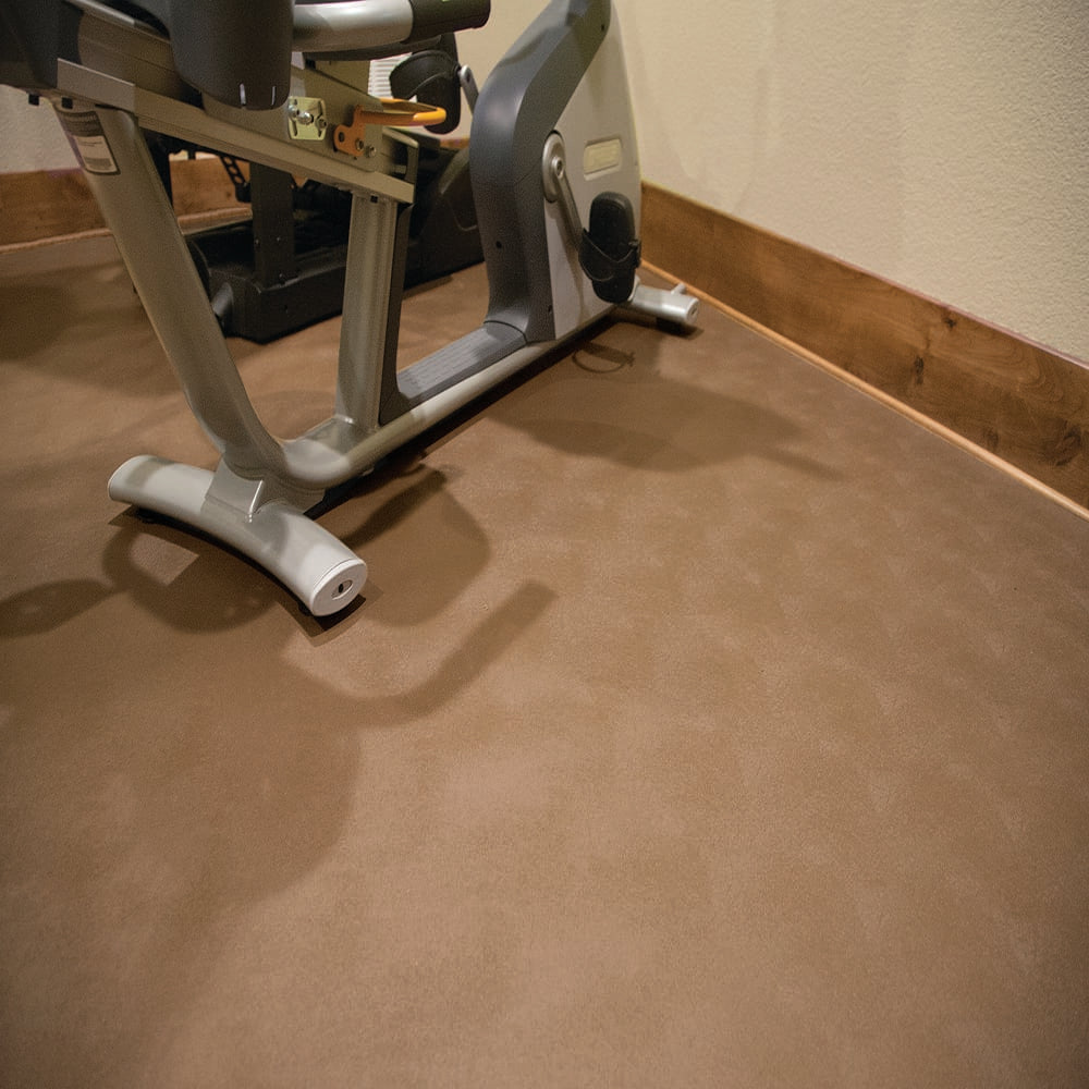 Stationary Exercise Bike Positioned On A Levant Flooring Adjacent To A Wall With Wooden Baseboards