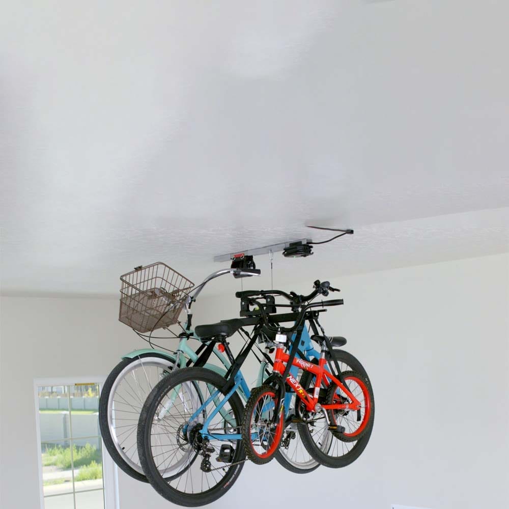 Three Bicycles Hoisted Up To The Ceiling By An Electric Bicycle Lift For Garage By SmarterHome
