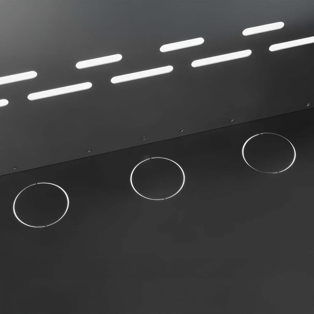 Three Pre Cut Circular Knockouts On A Black Metal Panel Below Slotted Ventilation Holes