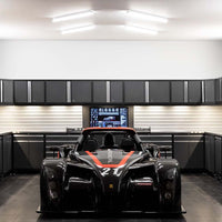 Well Lit Garage Featuring 3 Piece Wall Cabinet Set Pro 3.0 With Display Shelf And A Black Race Car