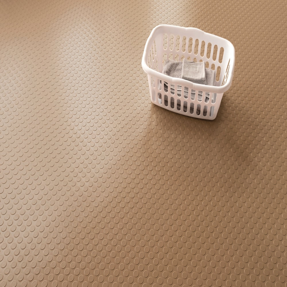White Plastic Laundry Basket Sits Atop A Beige G-Floor Large Coin Flooring With A Uniform Circular Pattern
