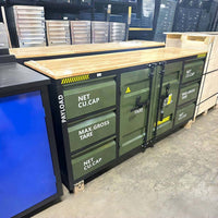 Workbench With A Wood Top Displayed In A Showroom Beside Other Storage Cabinets