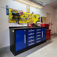Workbench With Drawers And Cabinets Set Below A Yellow Pegboard Filled With Hanging Tools